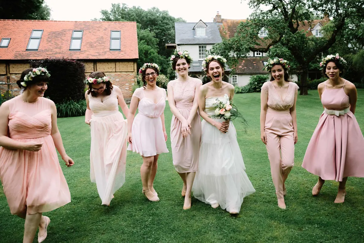 Bridesmaids walking with bride at wedding in Oxford