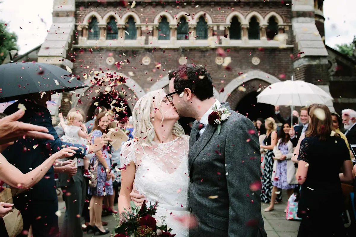 Bride + Groom covered in confetti - by Philippa James Photography - What if it rains on your wedding day
