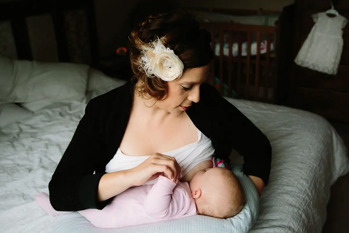 WEDDING PLANNING WITH CHILDREN blog post - bride breast feeding her baby