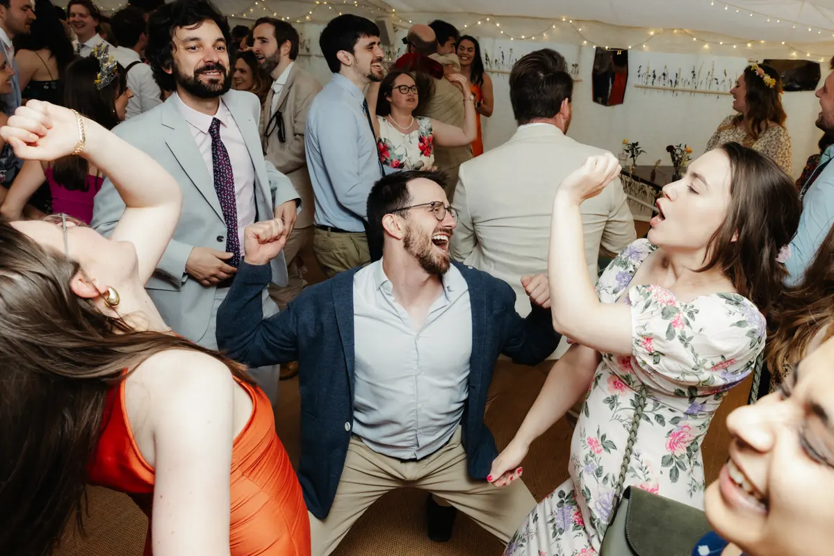 Guests dancing energetically on a crowded dance floor at the Perch