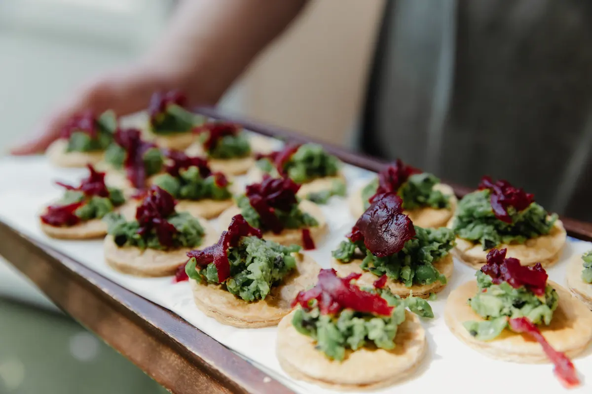 Tray of canapés topped with crushed peas and beetroot