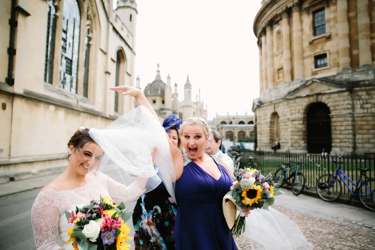 Bride walking toward Bodleian Library on her wedding day