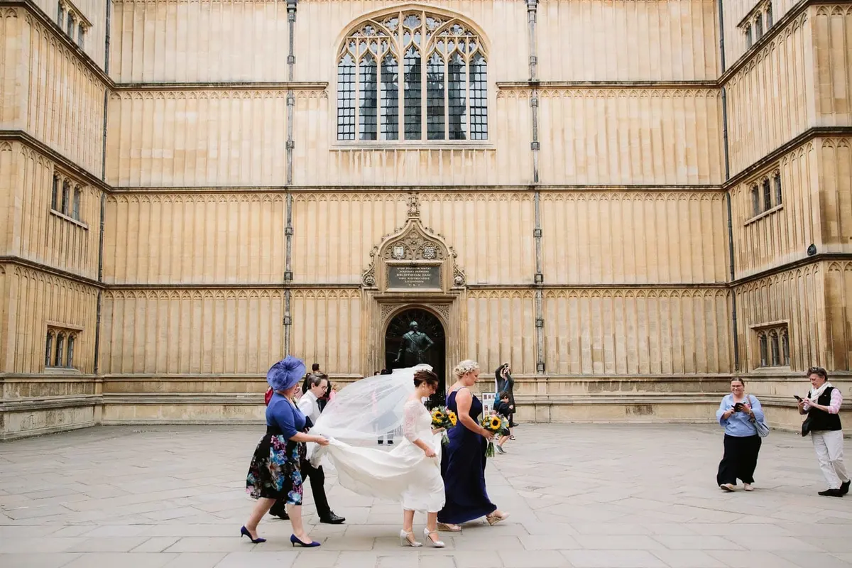Bodleian Library Wedding Photographer - bride walking through the quod