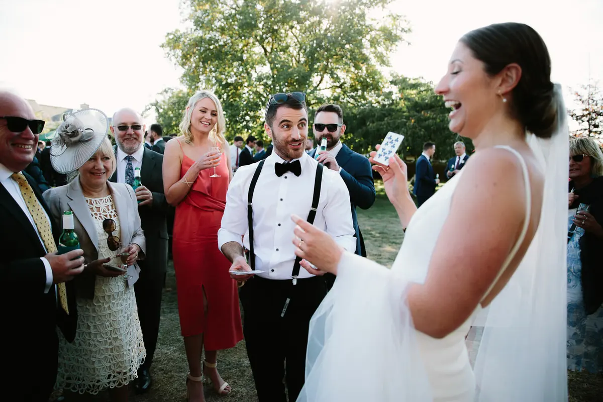 Bride laughing at magic trick at Manor Farm Barn Wedding venue