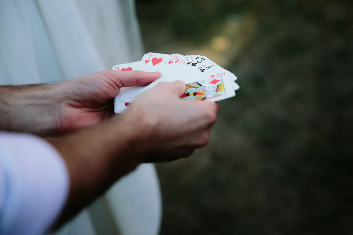Close-up of hands fanning out a deck of playing cards for a magic trick