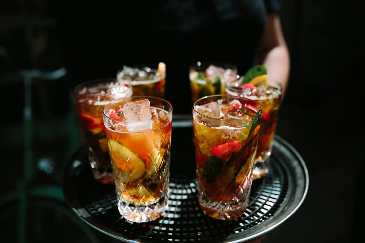 Tray of Pimm's in cut-glass tumblers with cucumber, strawberries and mint