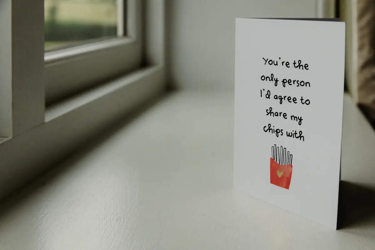 Card on a windowsill reading You're the only person I'd agree to share my chips with