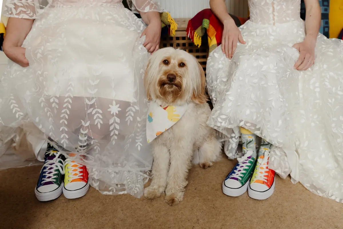 Two brides with their dog, preparing to get married