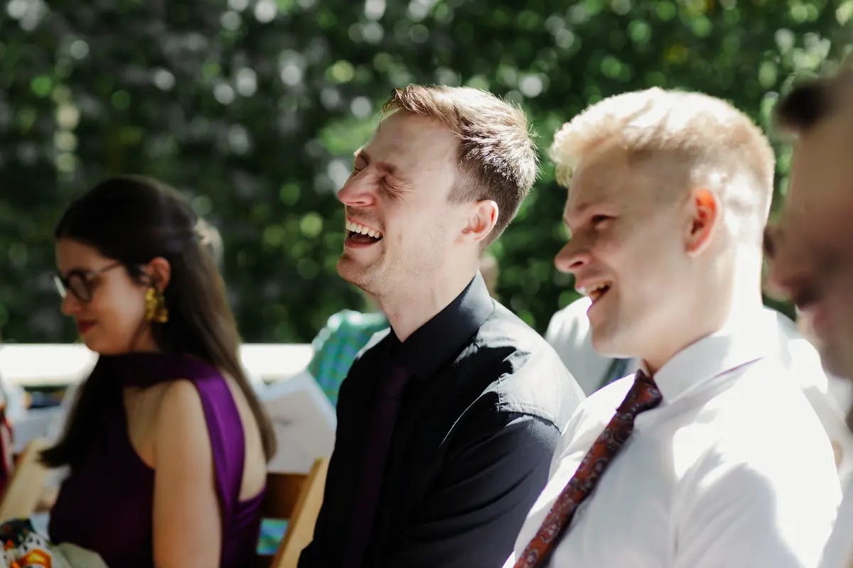 Guests watching outdoor wedding ceremony