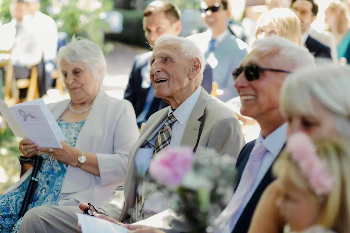 Guests at outdoor wedding ceremony at The Perch wedding venue Oxford